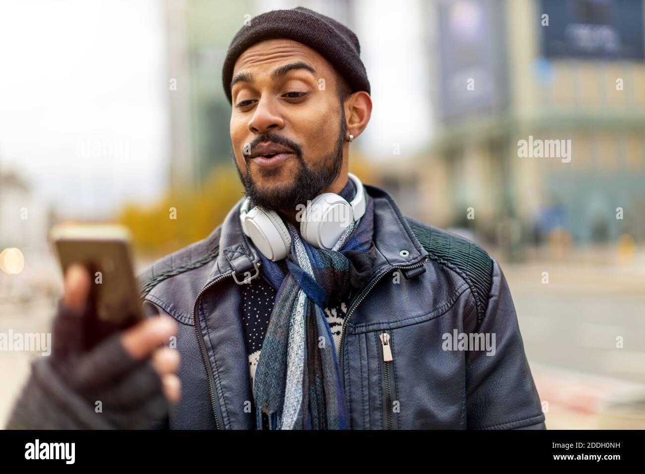 Handsome young man using mobile phone at the street Stock Photo