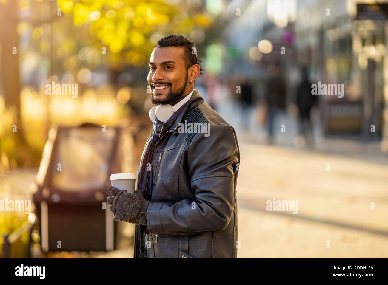 Handsome young young man drinking coffee in the street Stock Photo
