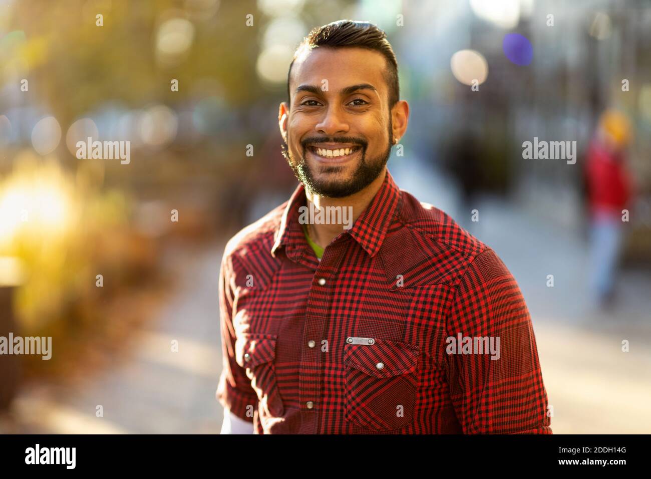 Portrait of a handsome young man on the city street Stock Photo