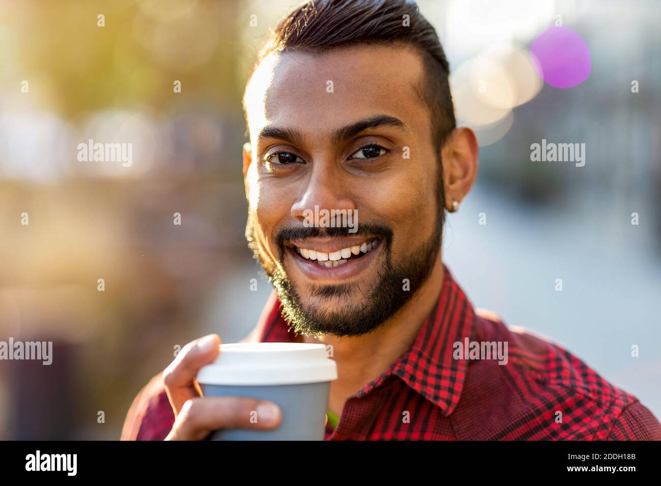 Handsome young young man drinking coffee in the street Stock Photo