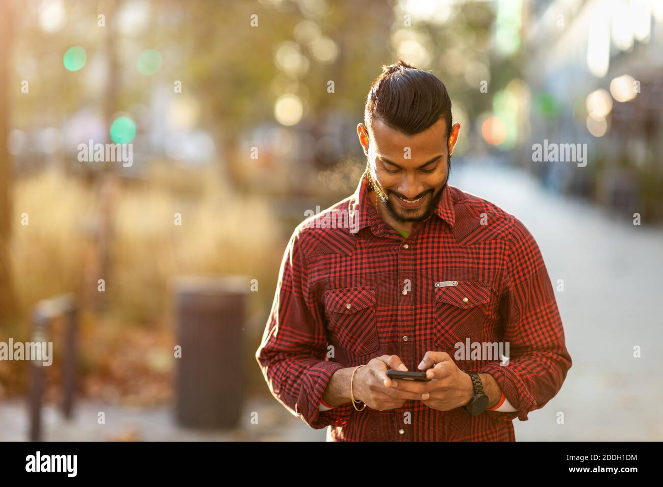 Handsome young man using mobile phone at the street Stock Photo