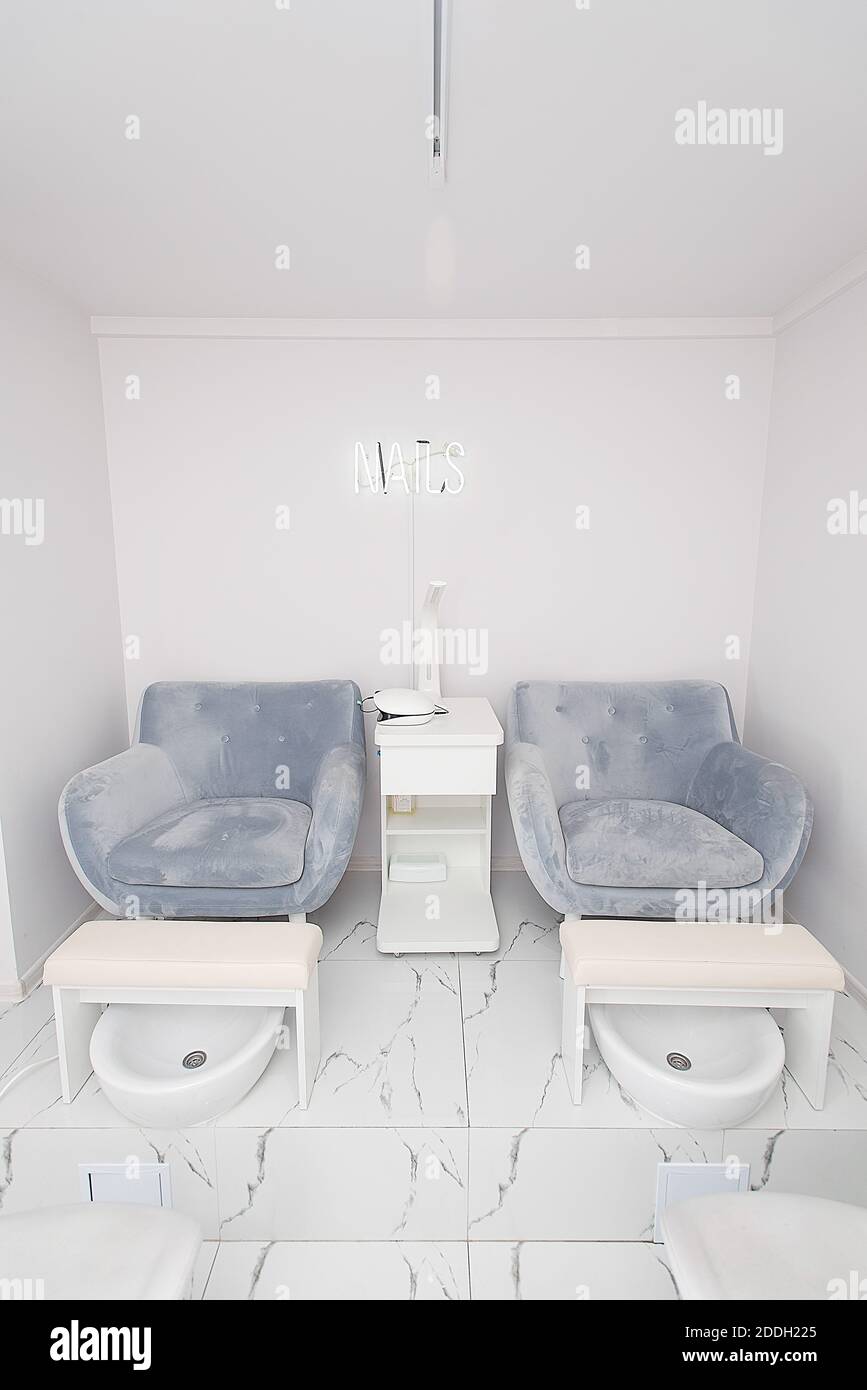 Interior of modern manicure salon without people. Luxury work places for masters of pedicure Stock Photo