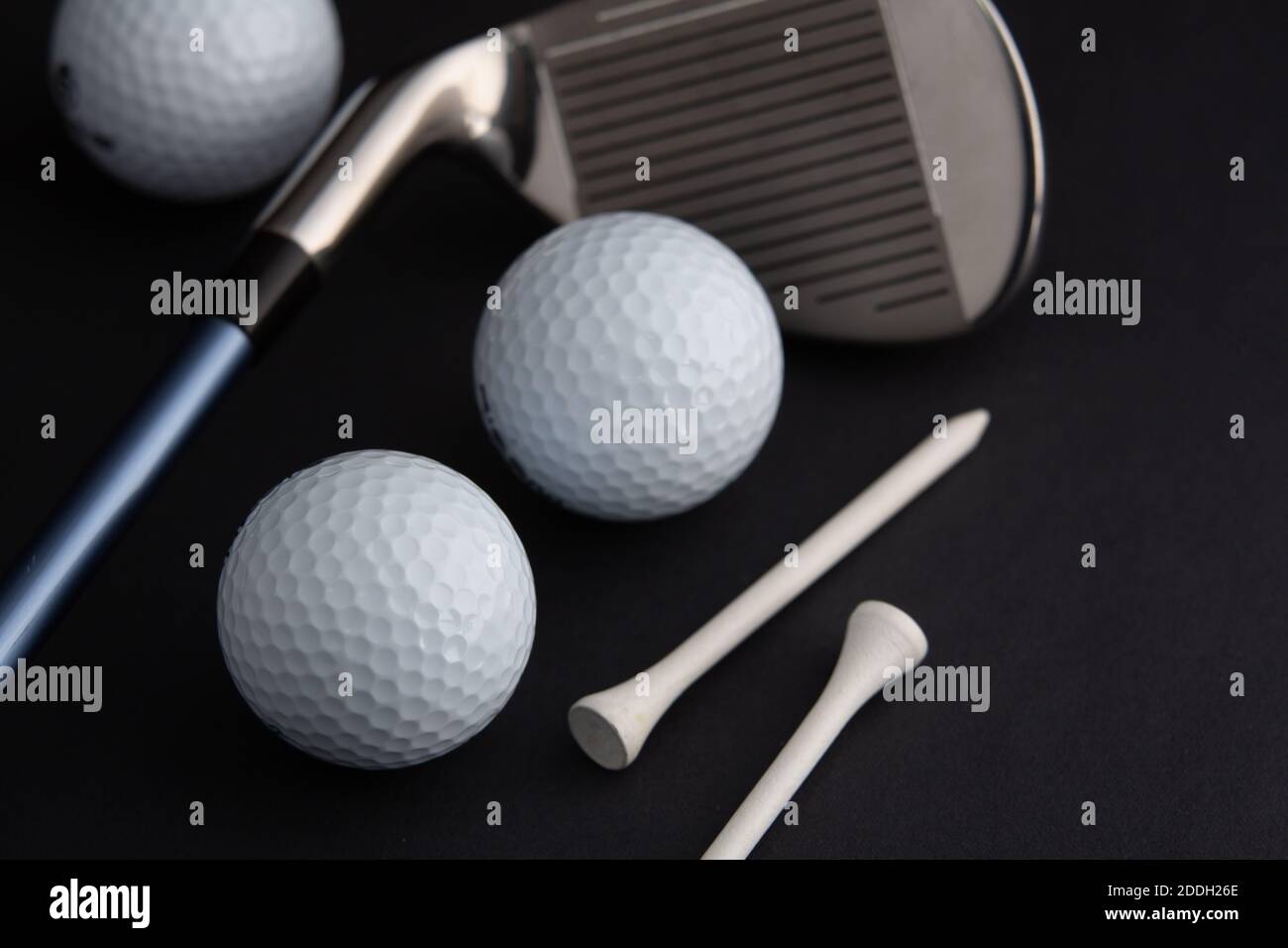 golf ball and iron stick seen very close. Black background Stock Photo