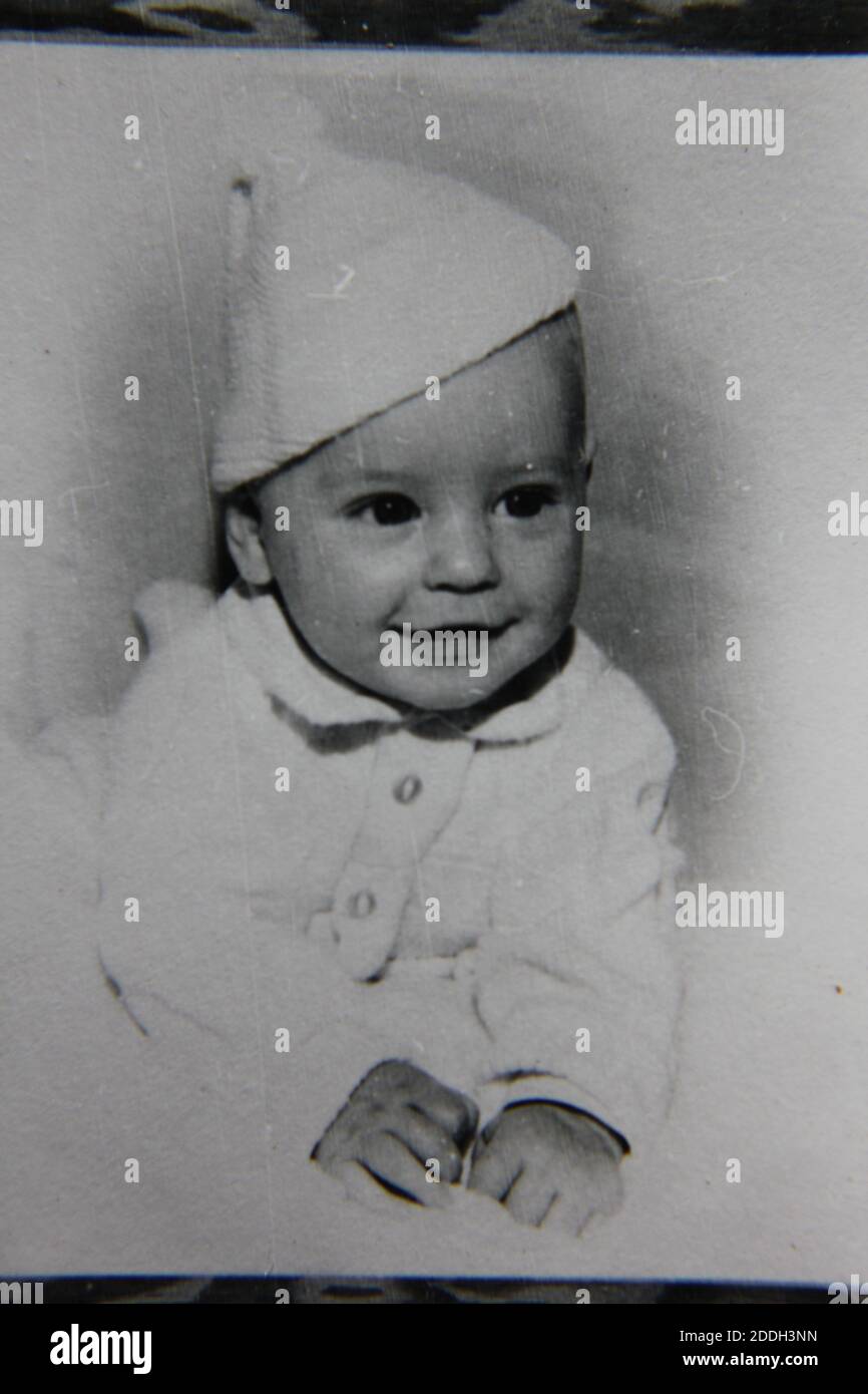 Fine 1970s vintage black and white photography of a cute baby wearing a