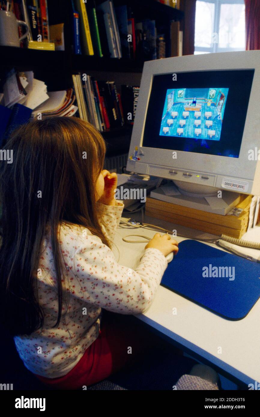 5 Year old girl On Computer Answering Questions on an Educational CD Rom Stock Photo