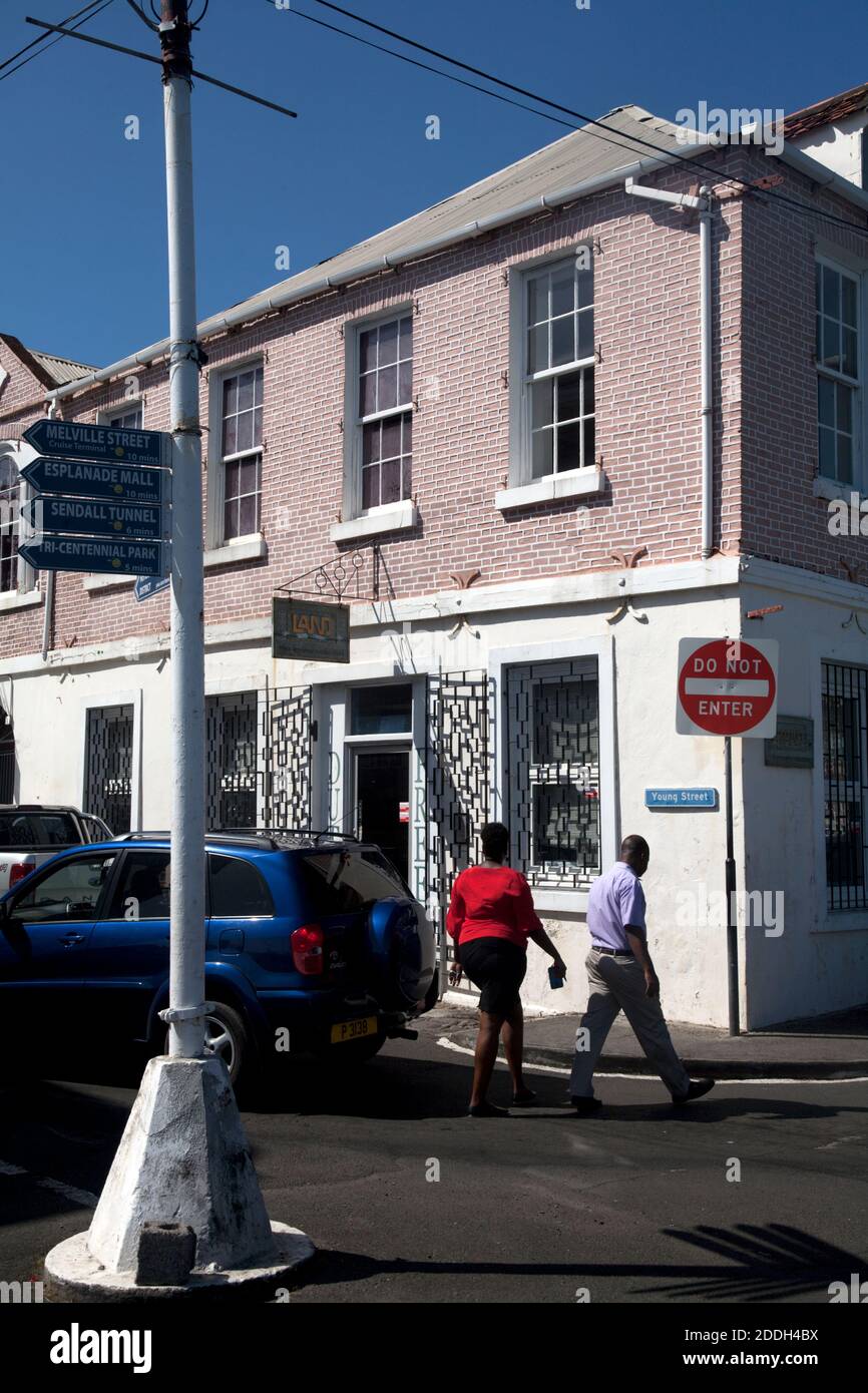couple crossing road young street bay town st george grenada leeward islands west indies Stock Photo