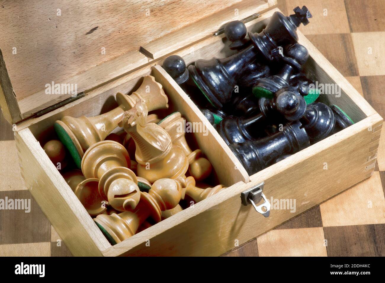 Old wooden box of wooden chess pieces. Stock Photo