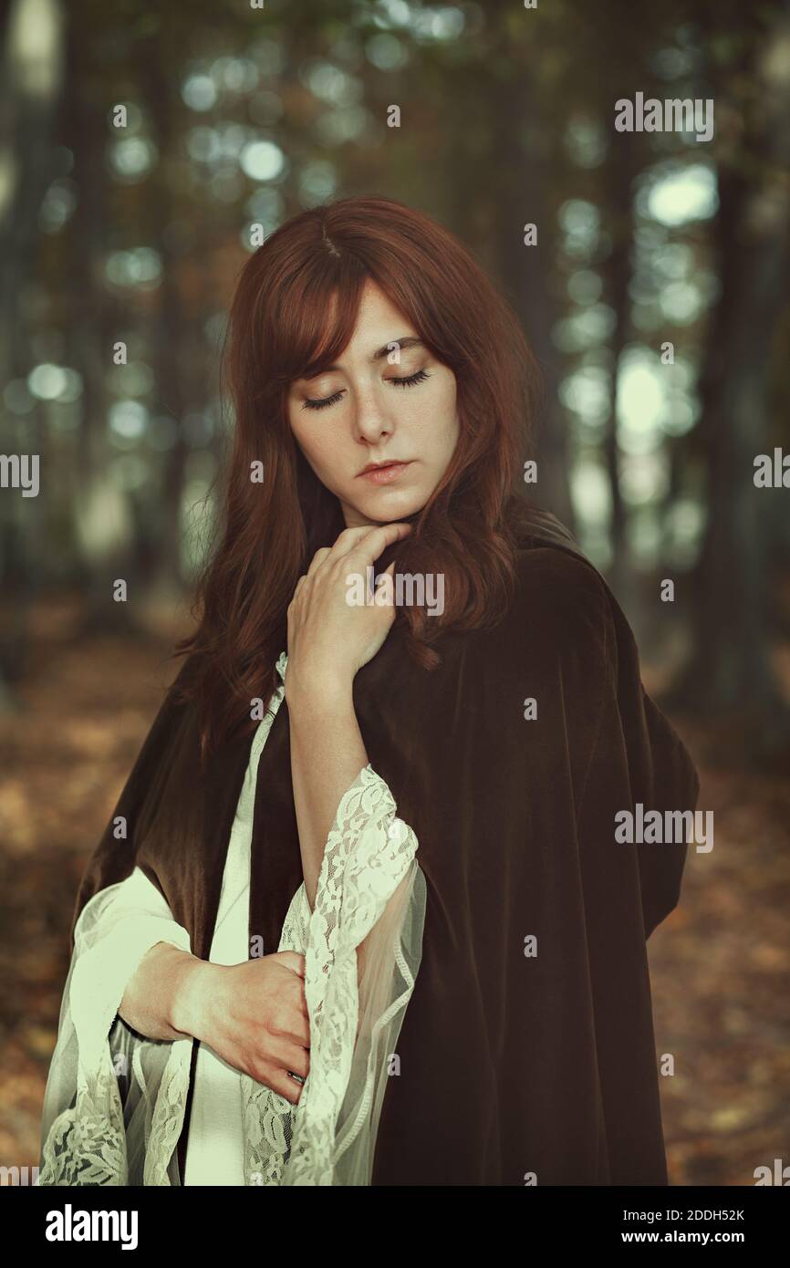 Medieval woman portrait in a forest. Vintage colors Stock Photo