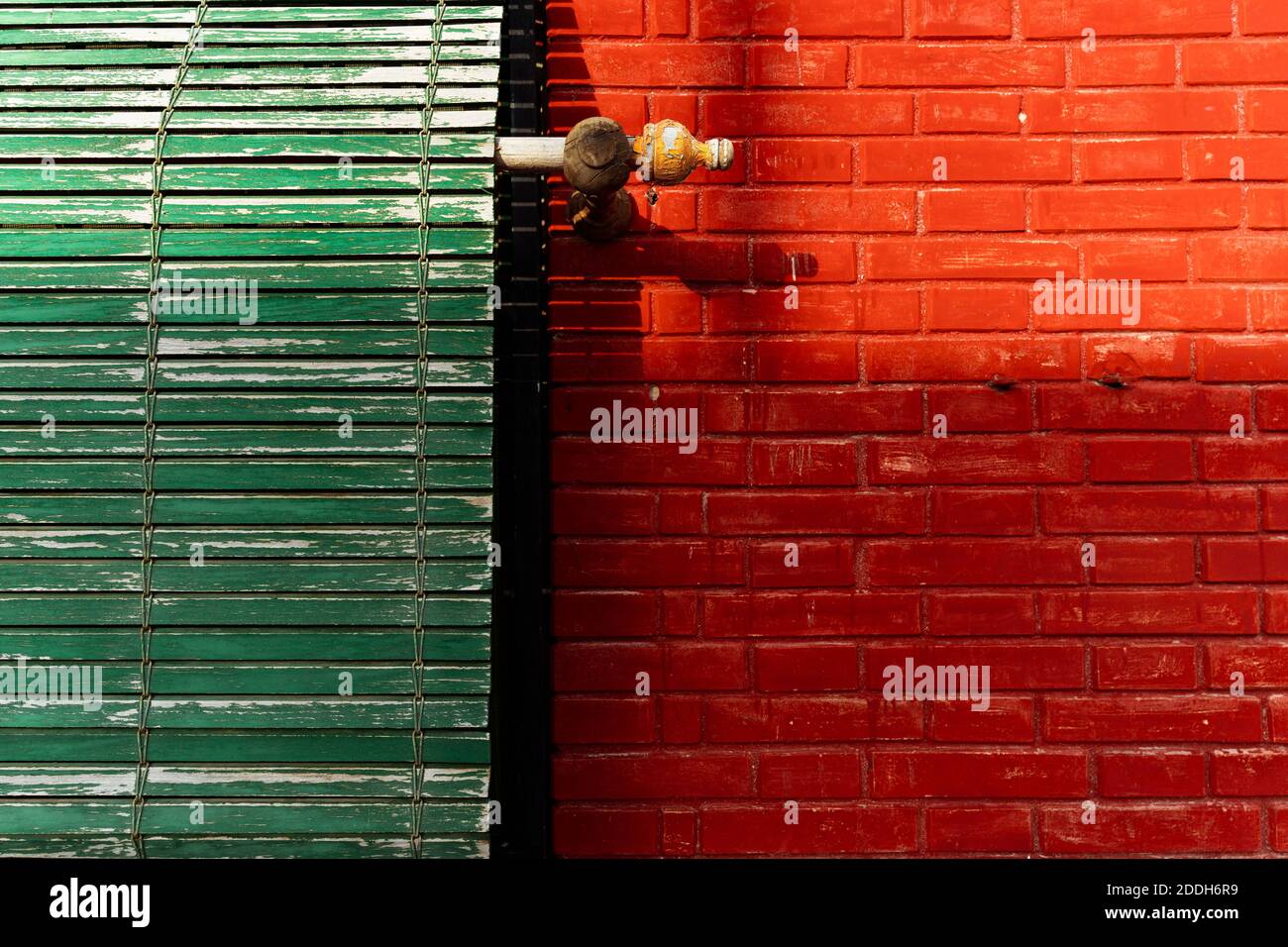 Green wooden blinds and red brick wall Stock Photo Alamy