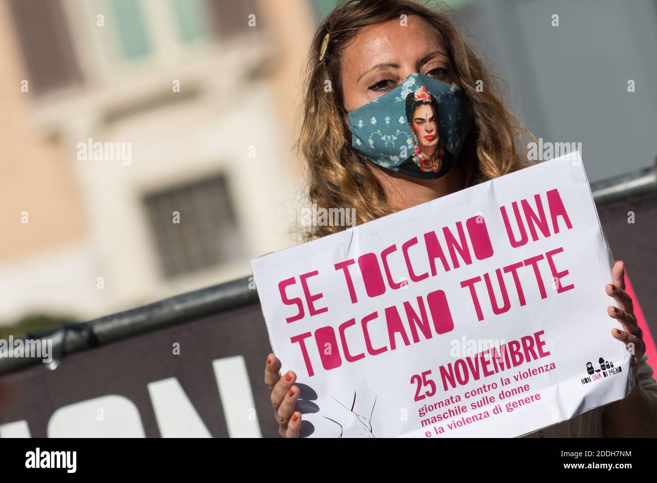 A protester holding a placard reading 'Se toccano una toccano tutte' (If  they touch one, they touch all) during a flash-mob organized by the "Non  una di meno" feminist movement, as part