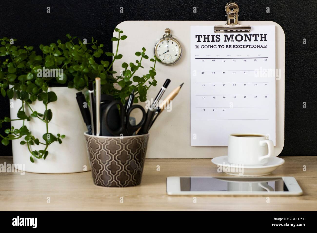 A quiet home office desk equipped with the necessary stationary to work from home. The tidy work space is conducive to productivity. Stock Photo