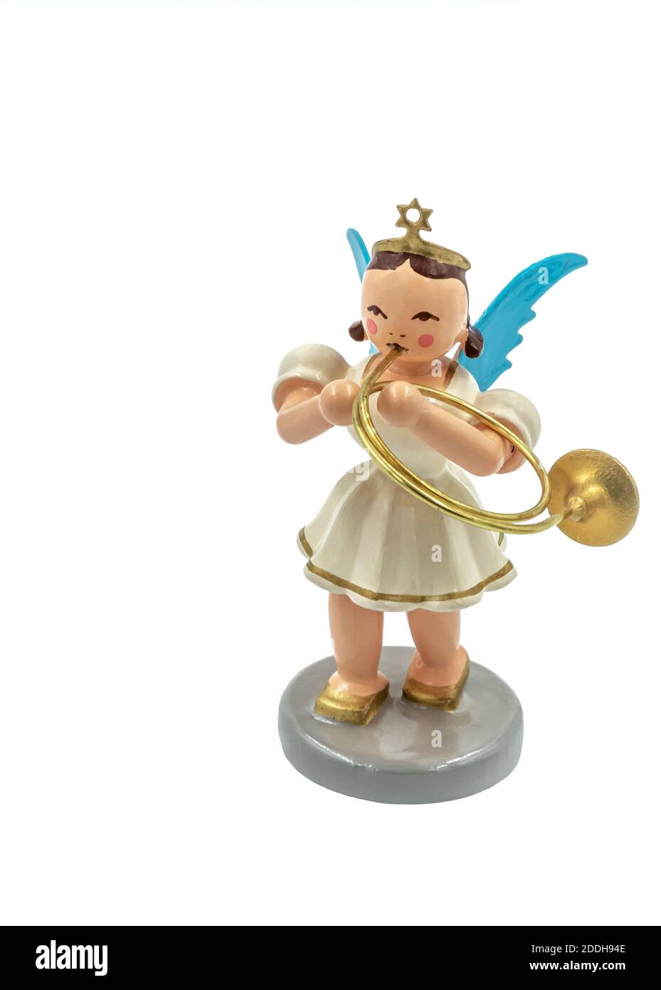 Closeup of a original handcarved wooden German Christmas Angel figurine cut out on a white background, playing a trumpet Stock Photo