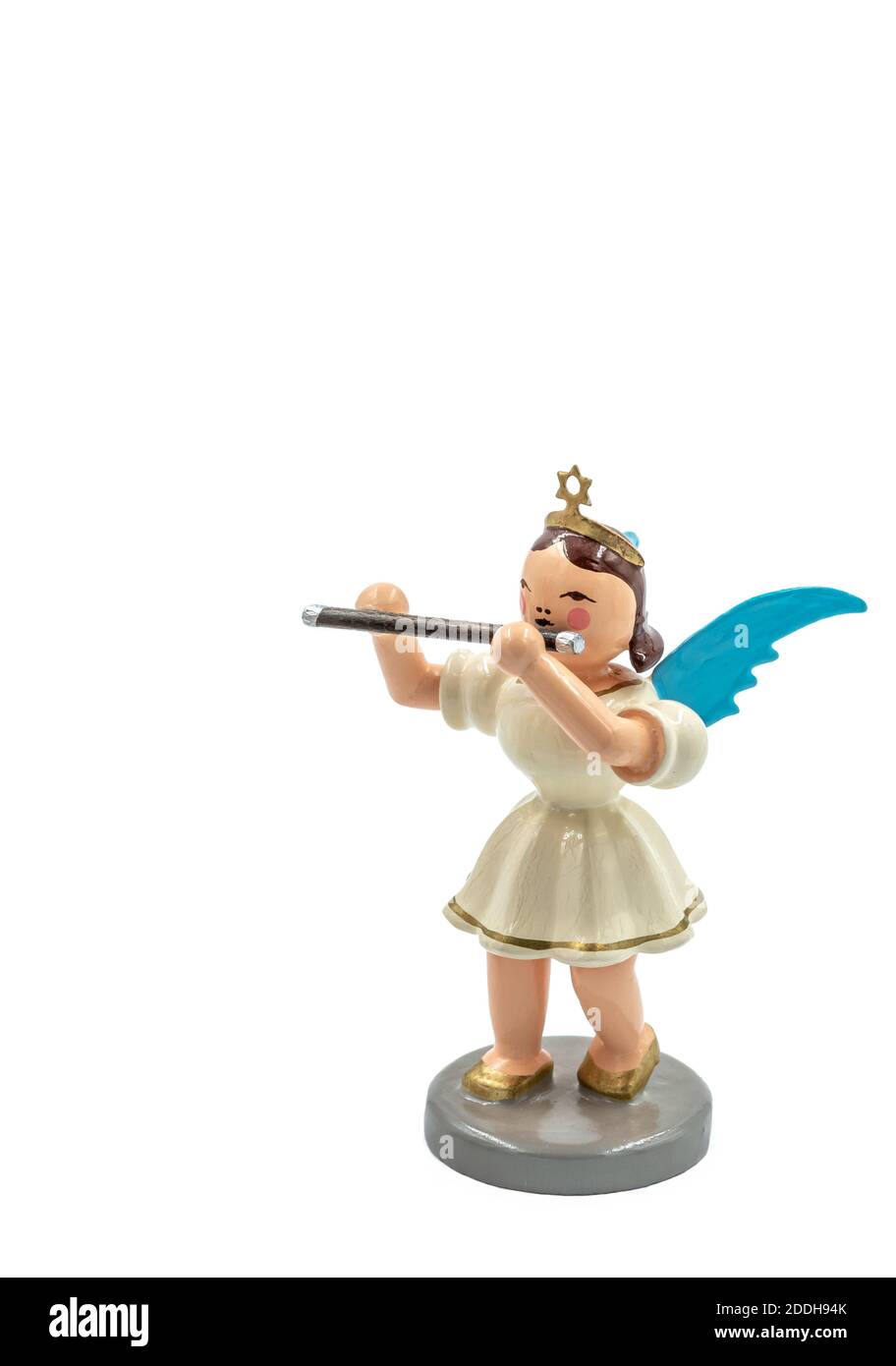 Closeup of a original handcarved wooden German Christmas Angel figurines with a flute cut out on a white background Stock Photo