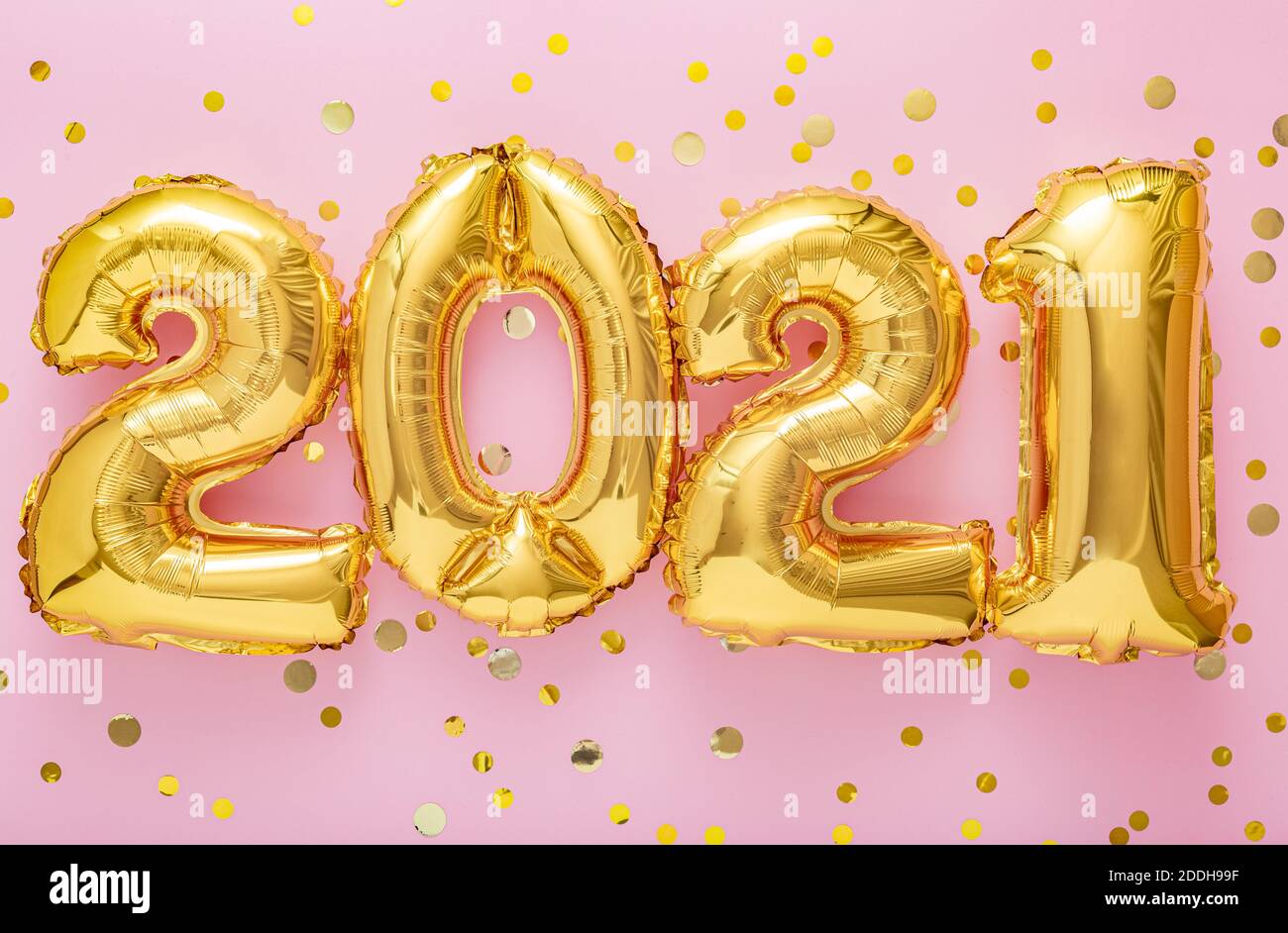 2021 air balloon gold numbers on pink background with golden confetti, Christmas, festive decor. Happy New year eve invitation with Christmas gold Stock Photo