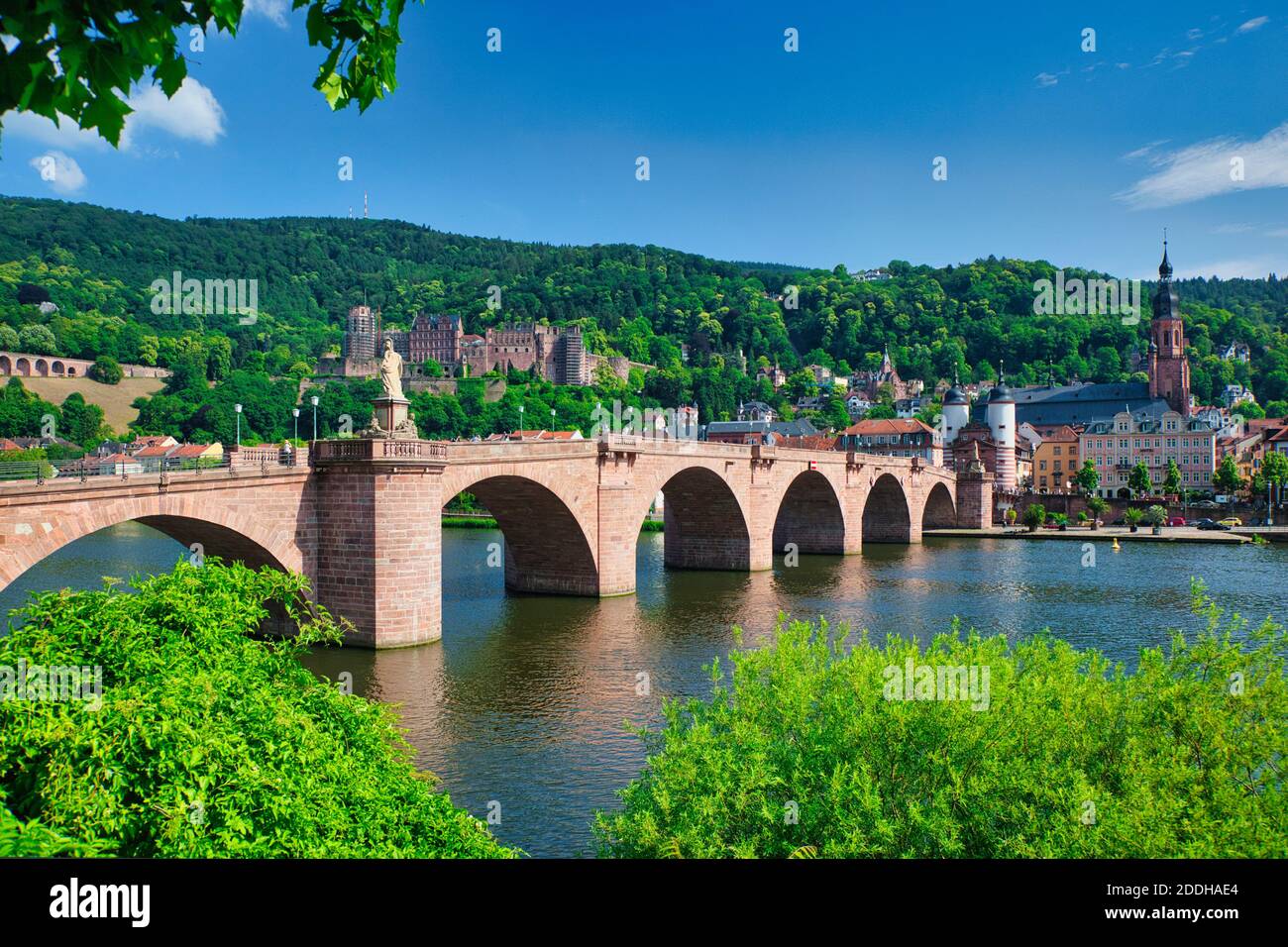 A lovely old bridge spanning the River Rhine at Heidelberg in Baden-Württemberg, Germany, crossing the River Rhine, with a backdrop of the town Stock Photo