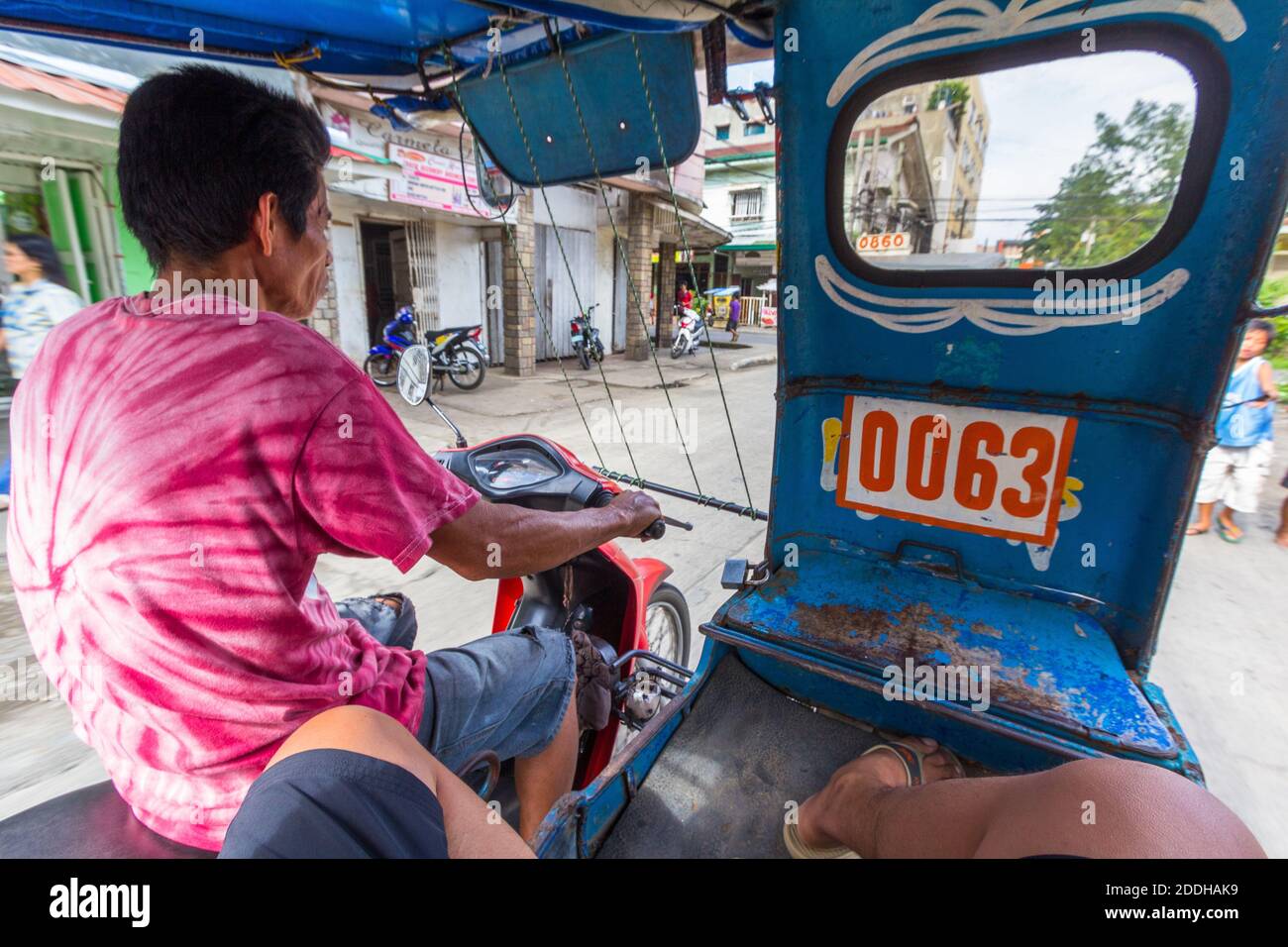 A custom built tricycle driver, a local passenger vehicle in Mindanao