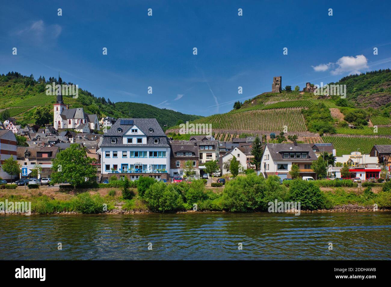 A townscape viewed from the River Rhine in Germany, with buildings and  Church with tower on a hill in the background plus a castle high on the right Stock Photo