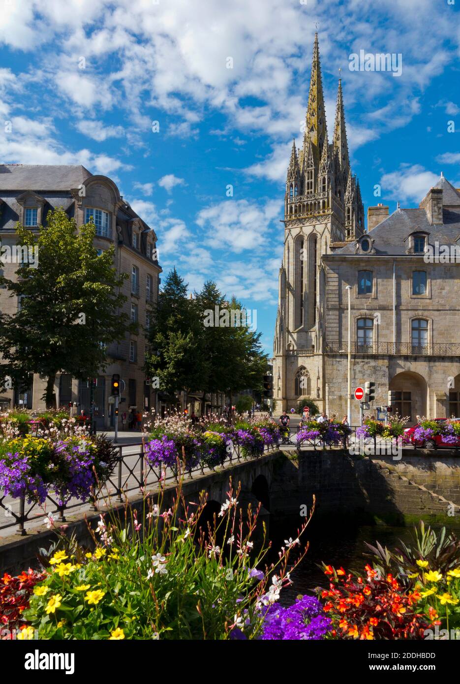 Bridge decorated with flowers over the River Odet in the centre of Quimper a city in Finistere Brittany north west France with cathedral in background Stock Photo