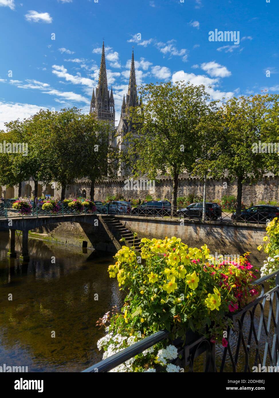 Bridge decorated with flowers over the River Odet in the centre of Quimper a city in Finistere Brittany north west France with cathedral in background Stock Photo