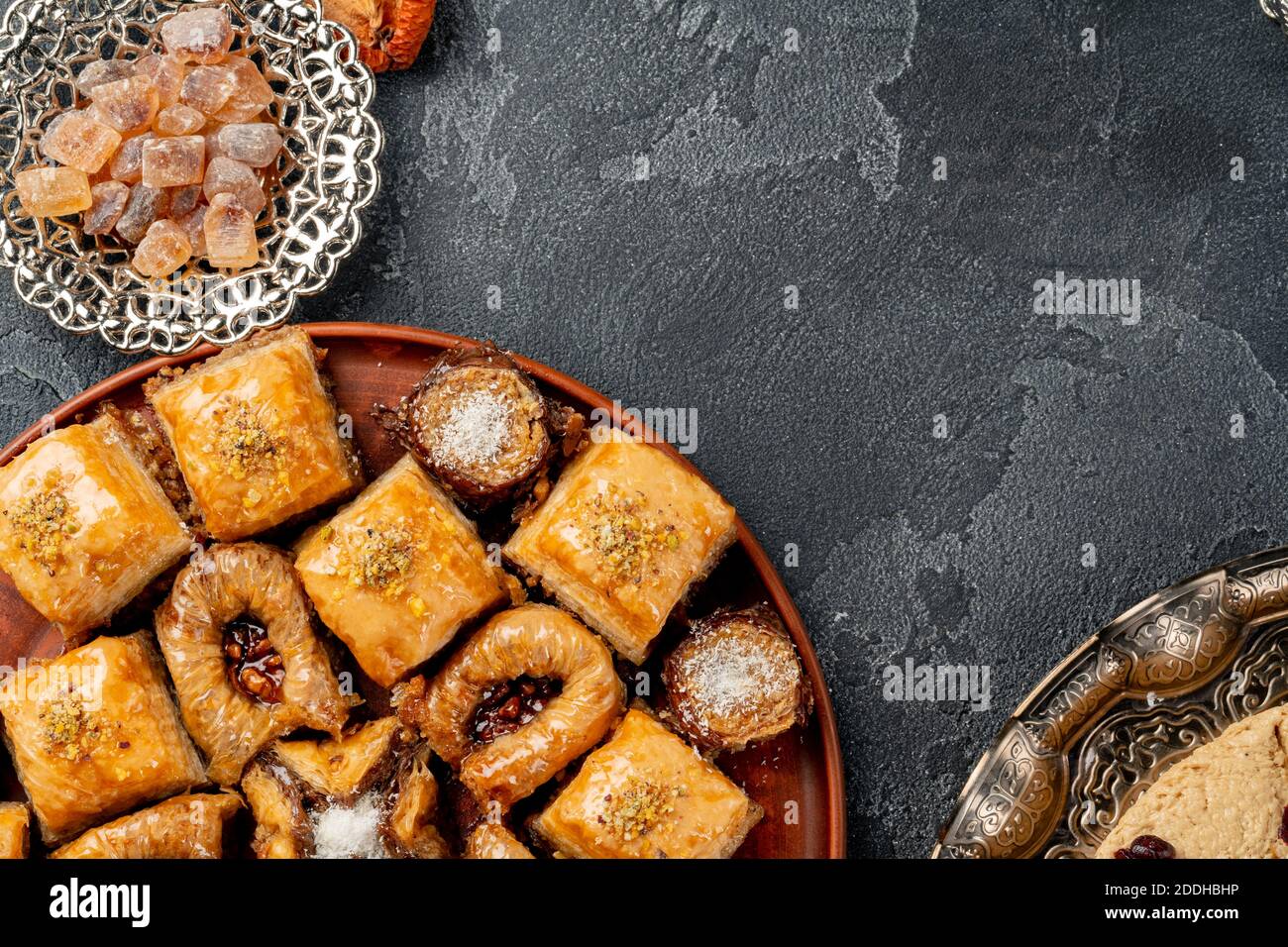 Assortment of turkish baklava on black textured surface Stock Photo