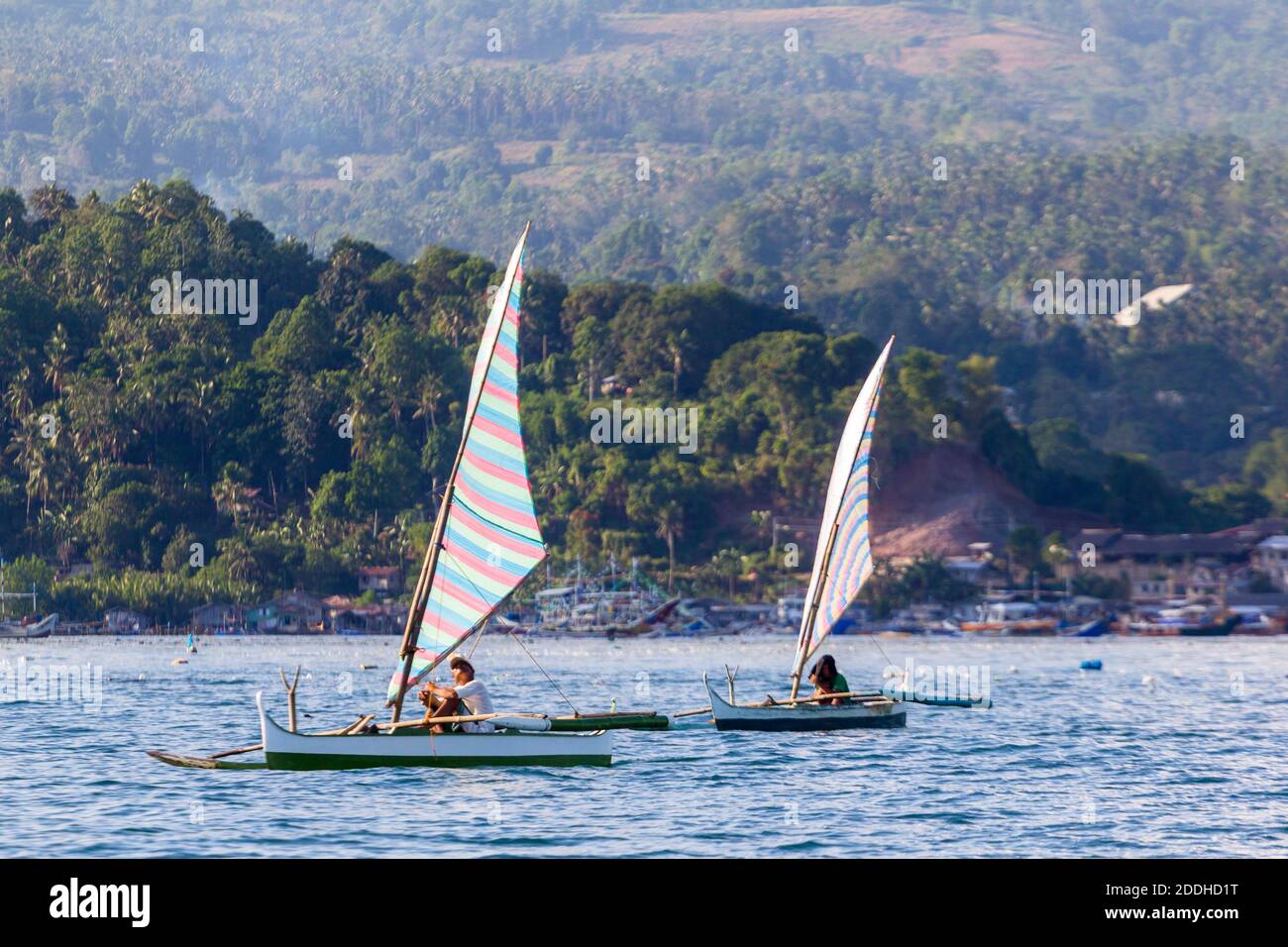 Filipino fishermen on their sailboats out at sea in Pagadian City, Philippines Stock Photo