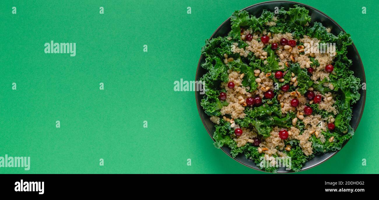 Healthy raw kale and quinoa salad with cranberry and pine nut. Top view