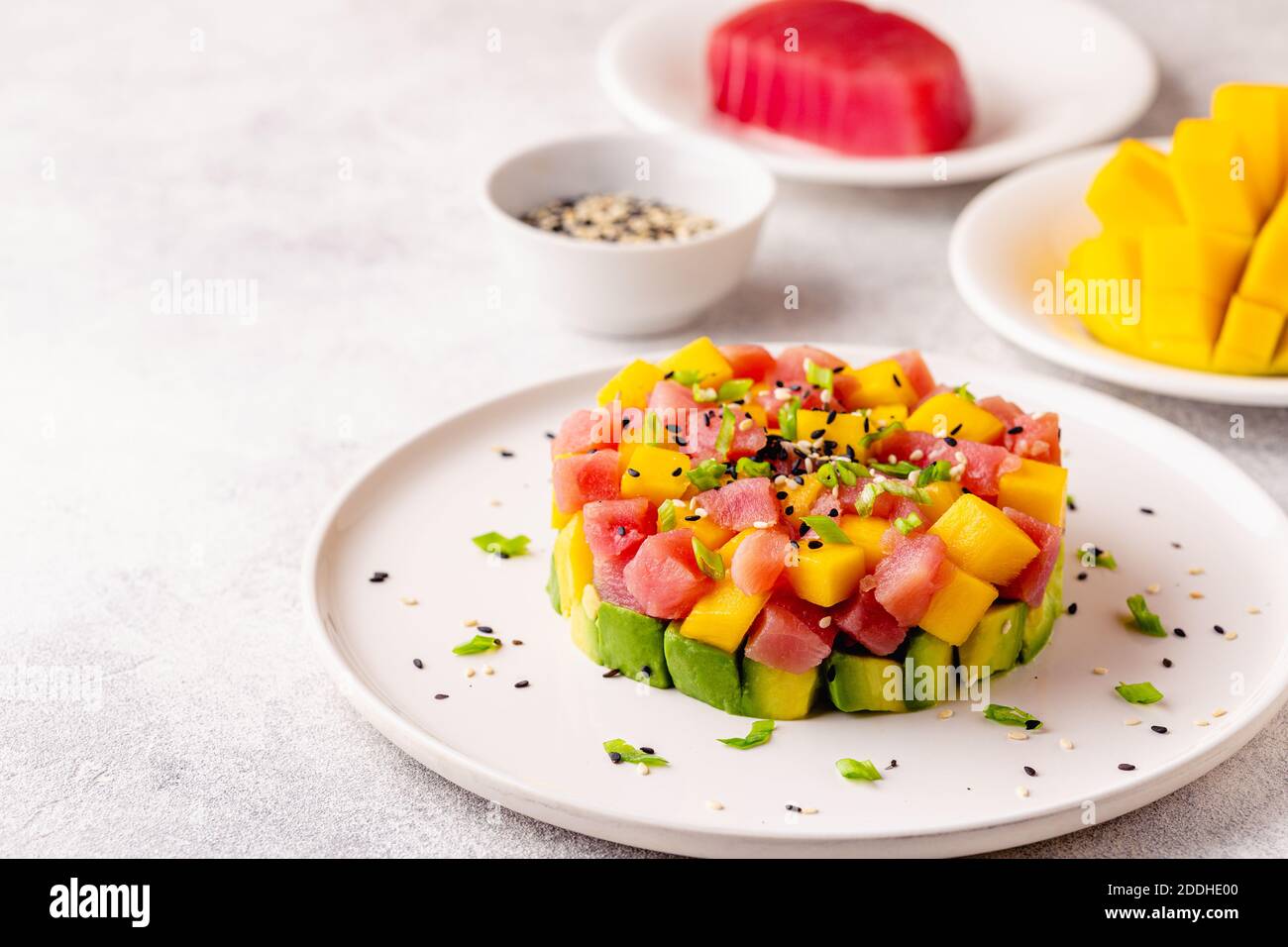 Tuna mango avocado salad tartare served with green onions and sesame seeds  Stock Photo - Alamy