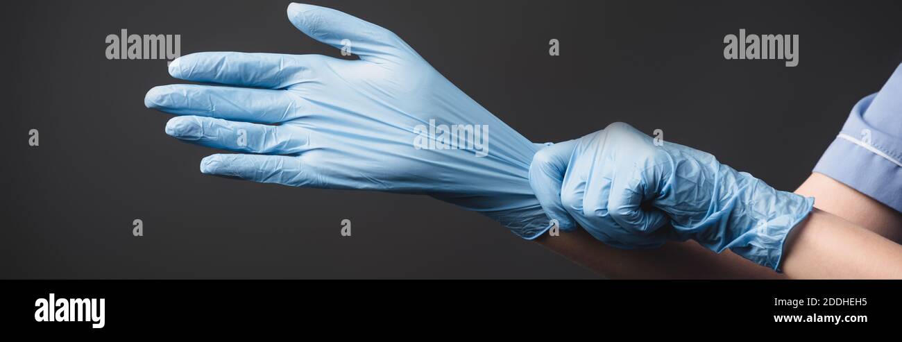 cropped view of nurse wearing latex gloves isolated on dark grey