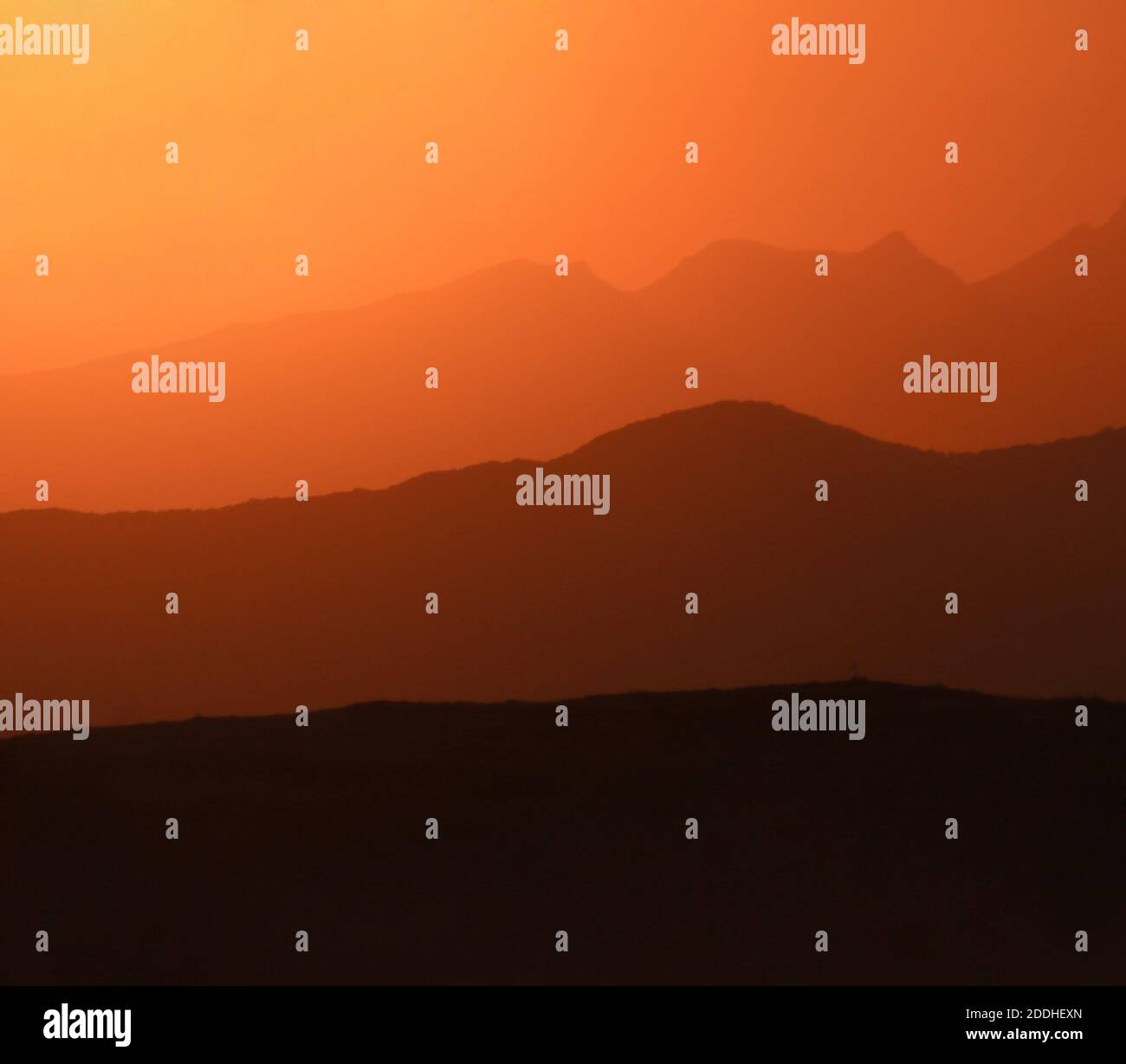 A mesmerizing view of misty mountains at sunset Stock Photo - Alamy