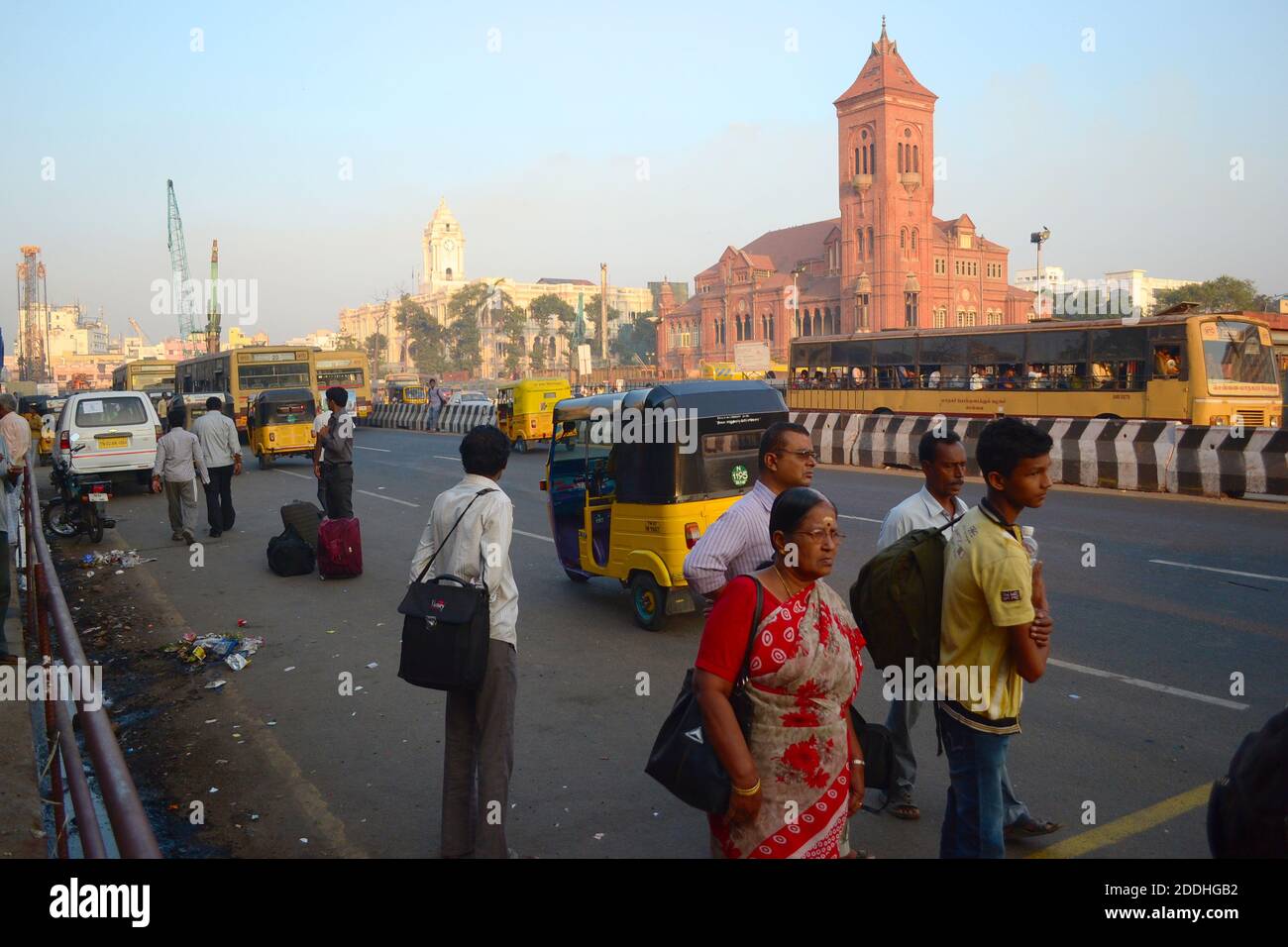 Chennai, Tamil Nadu, India - March, 2014:  People waiting bus or tuk tuk taxi on a bas stop against The Victoria Memorial Hall building Stock Photo
