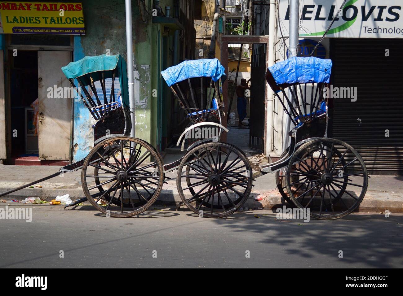 Kolkata, India - March, 2014: Three empty hand pulled rickshaw carts parked along the road on street in historical town in Calcutta Stock Photo