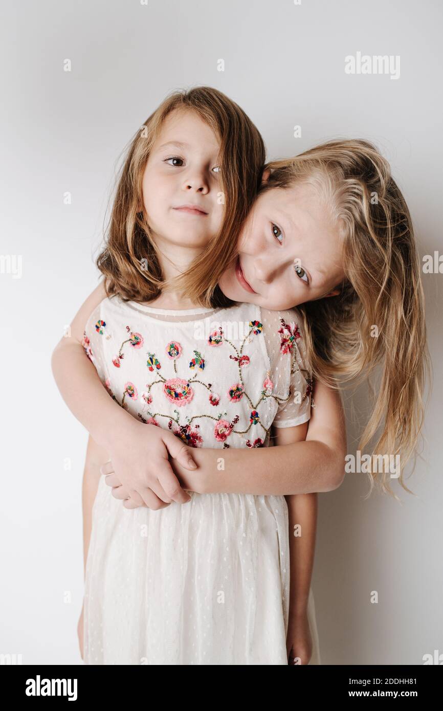Brother hugging sister from behind. Siblings of elementary school age together Stock Photo