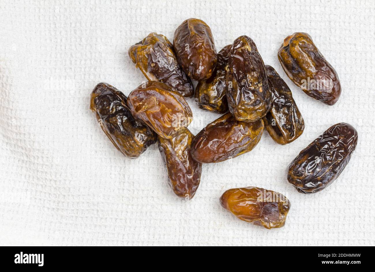 Dried dates on white cloth - top view image with copy space Stock Photo