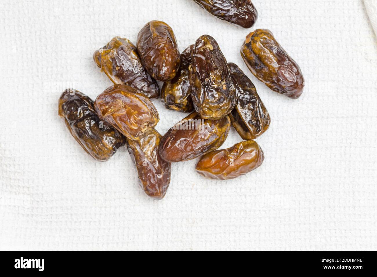 Dried dates on white cloth - top view image with copy space Stock Photo