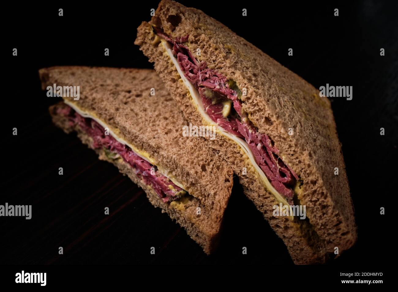 Pastrami sandwich on rye bread, pickle, gherkin, mustard and emmental