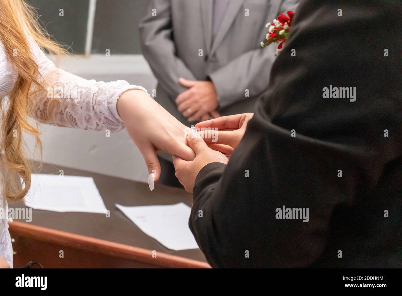 Holding hands with wedding rings Stock Photo