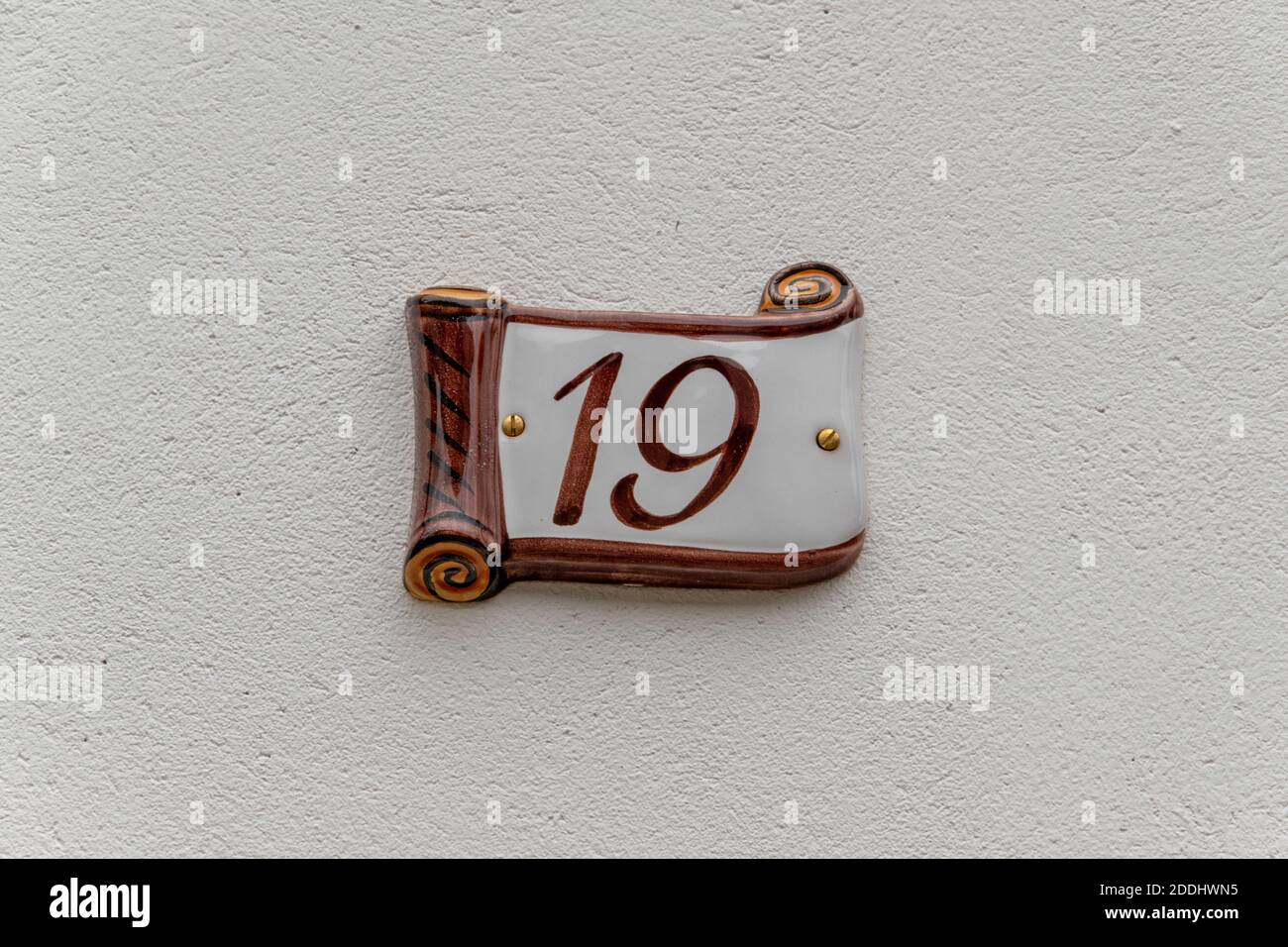 House number 19 on ceramic on a white house wall Stock Photo