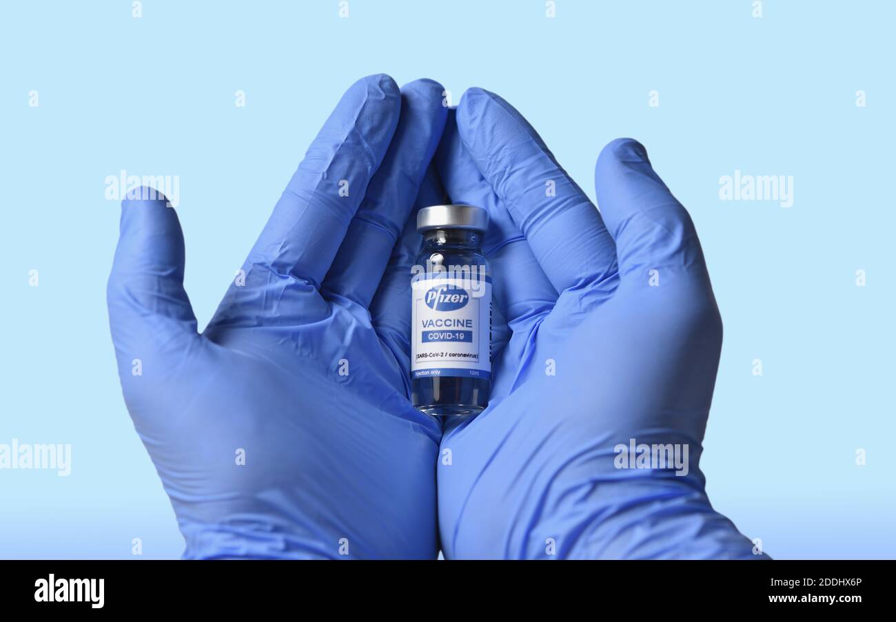 STARIY OSKOL, RUSSIA - NOVEMBER 23, 2020: Doctor with hope of salvation holds new vaccine for coronavirus made by Pfizer Stock Photo