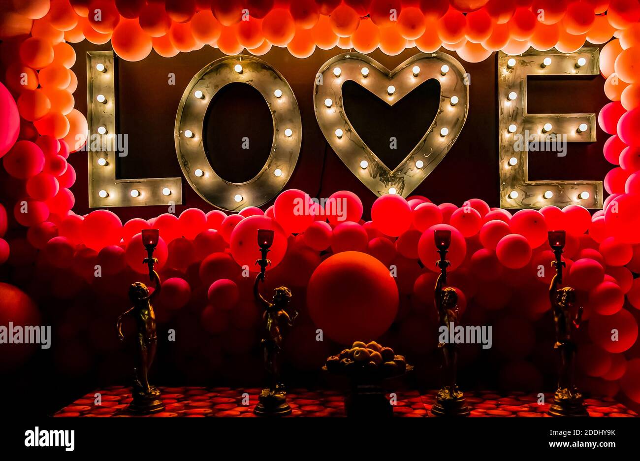 A beautiful lit love sign with lights and balloons Stock Photo - Alamy