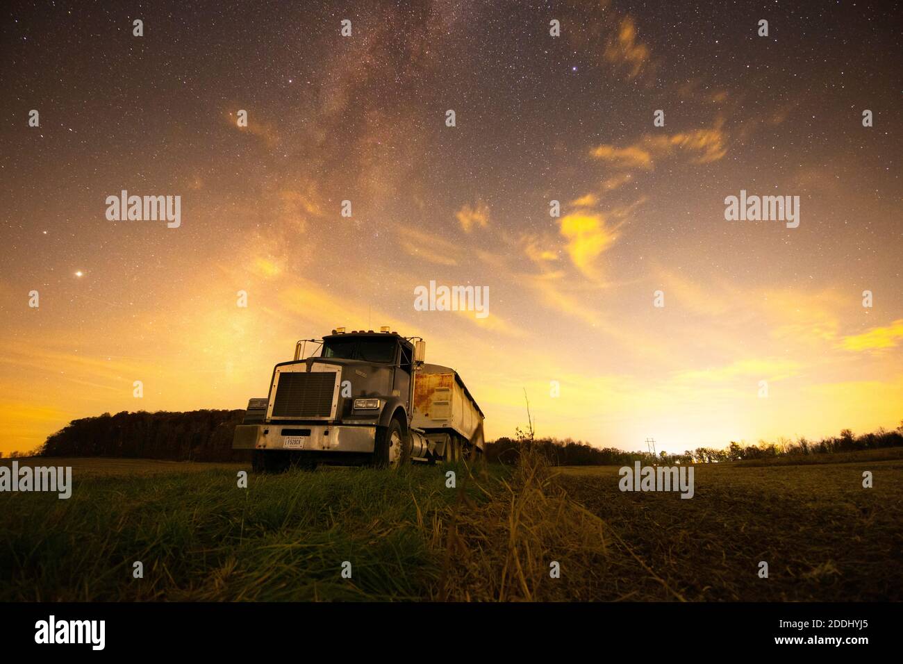 An old semi sits in a field under the stars of October during harvest season in Southern Indiana. Stock Photo