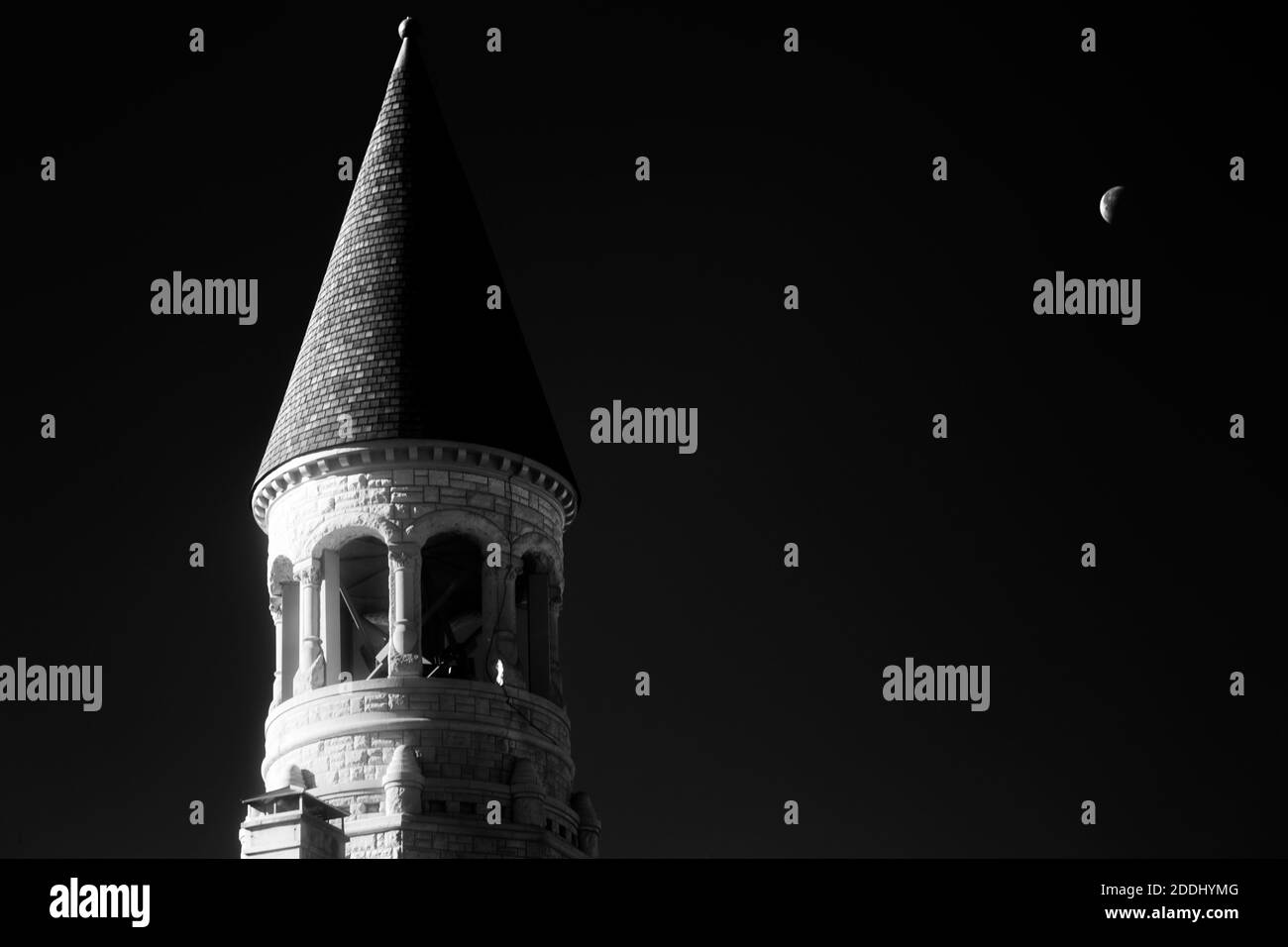 Infrared image of the spire atop the courthouse in Salem, IN.  A crescent moon gets in on the action Stock Photo