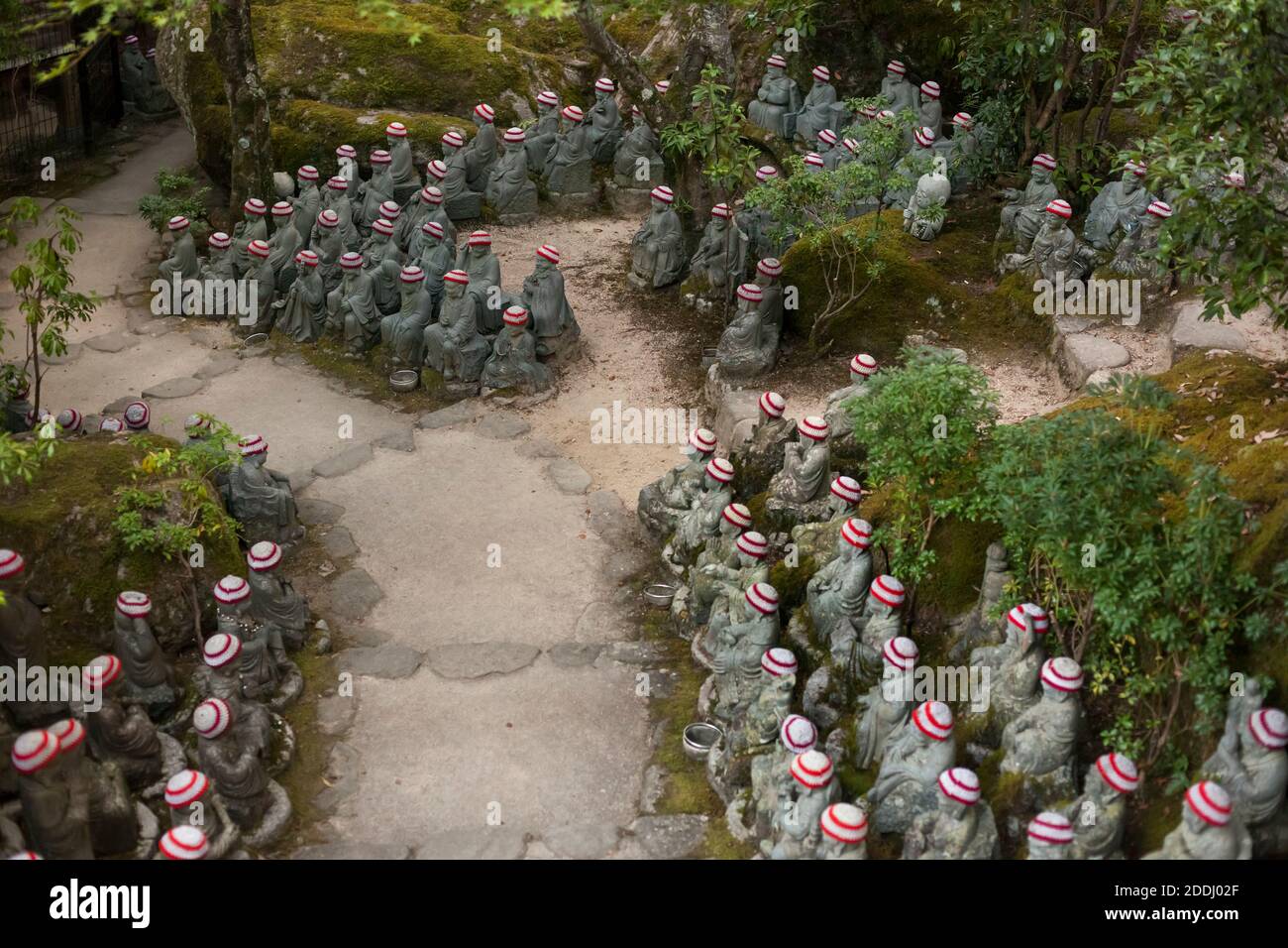 https://c8.alamy.com/comp/2DDJ02F/high-angle-view-of-hundreds-of-rakan-statuettes-with-woolen-bonnets-lined-up-by-the-stone-pathway-to-daisho-in-buddhist-temple-mt-misen-miyajima-2DDJ02F.jpg