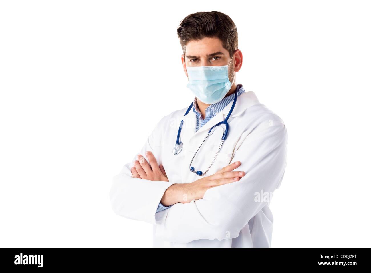 Portrait shot of male doctor wearing face mask while standing with arms crossed at isolated white background. Copy space. Stock Photo