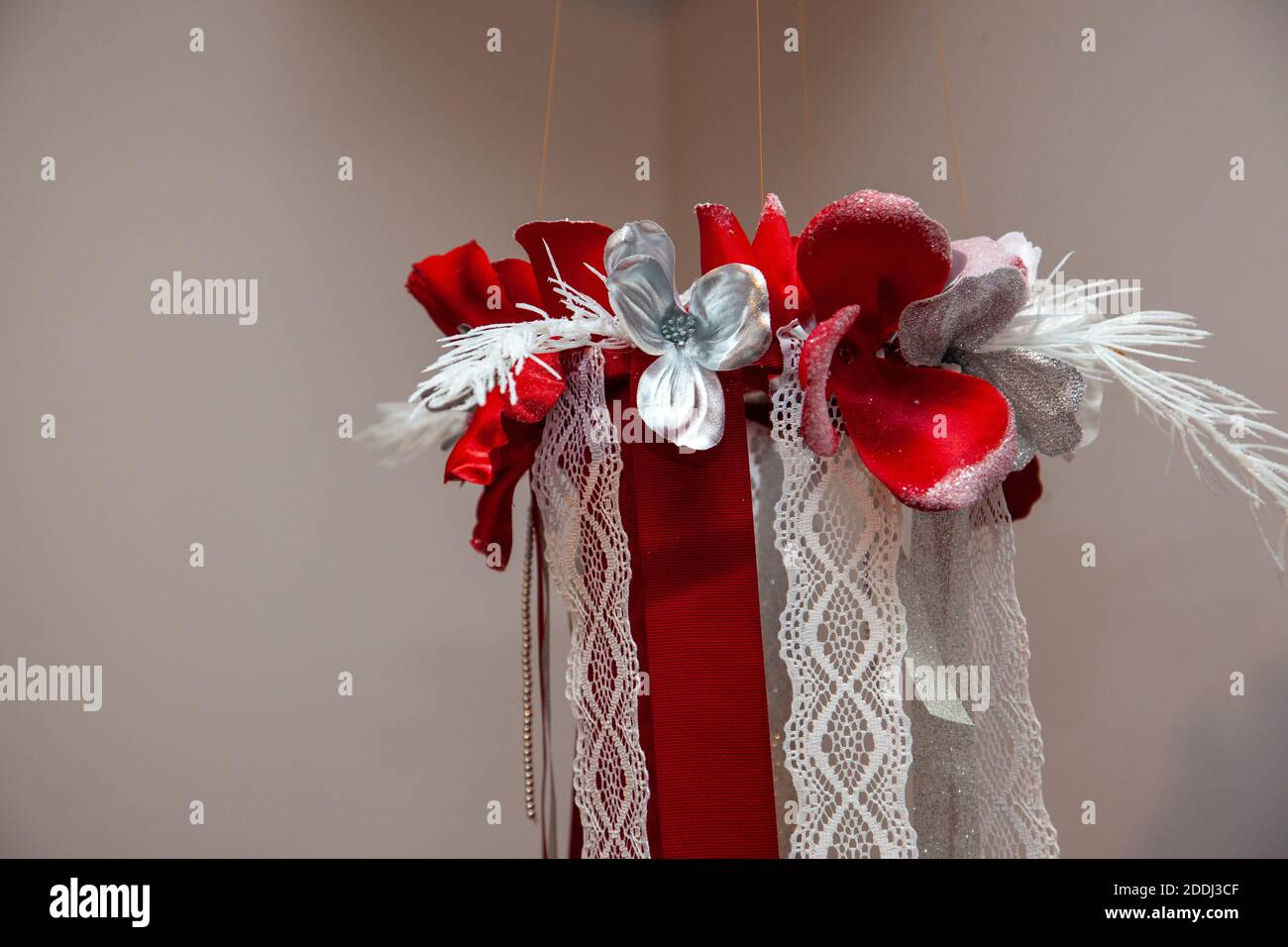 a decorative holiday christmas chandelier made of fabric and flowers Stock Photo
