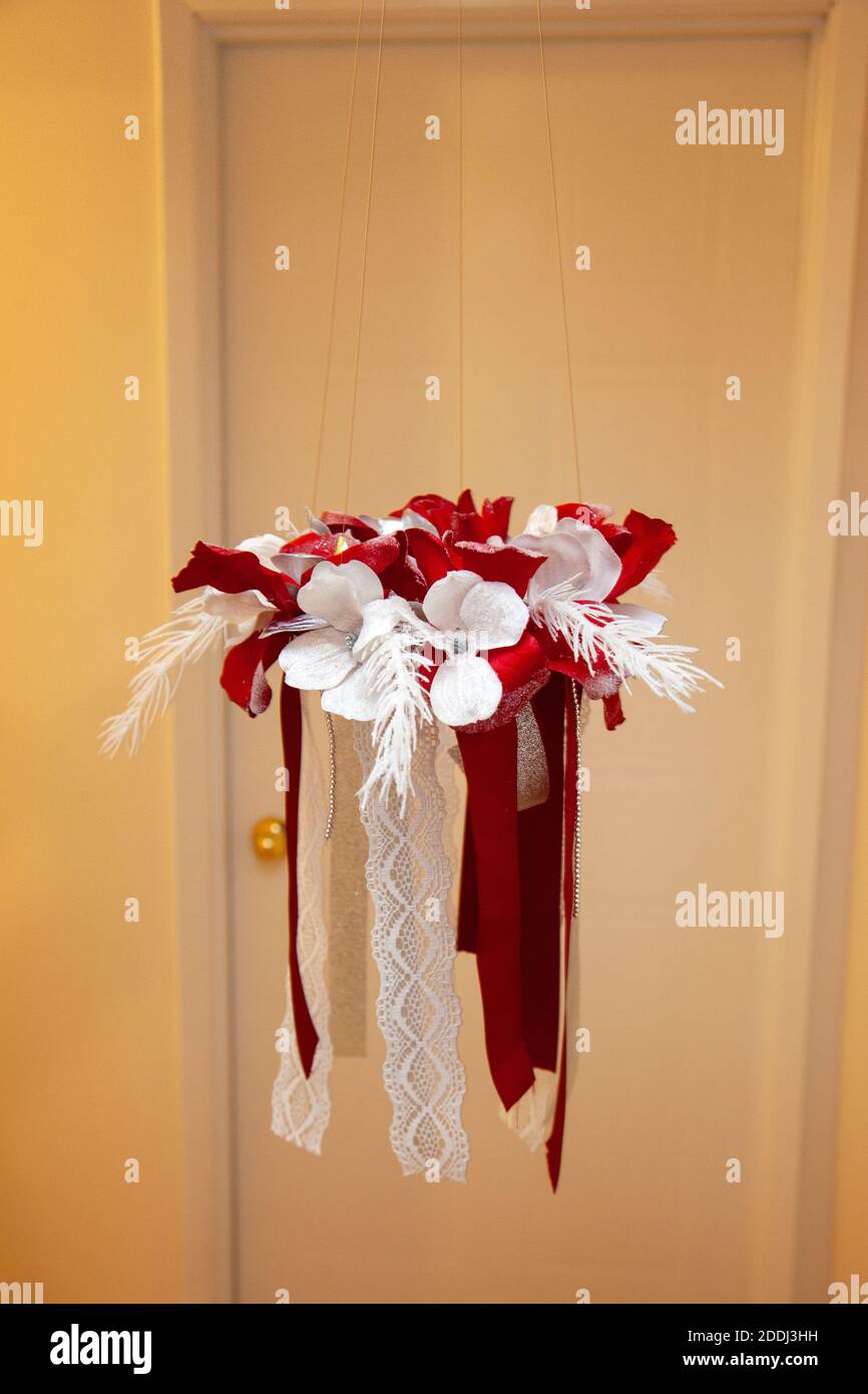 hand made floral chandelier wreath hanging from a doorway Stock Photo