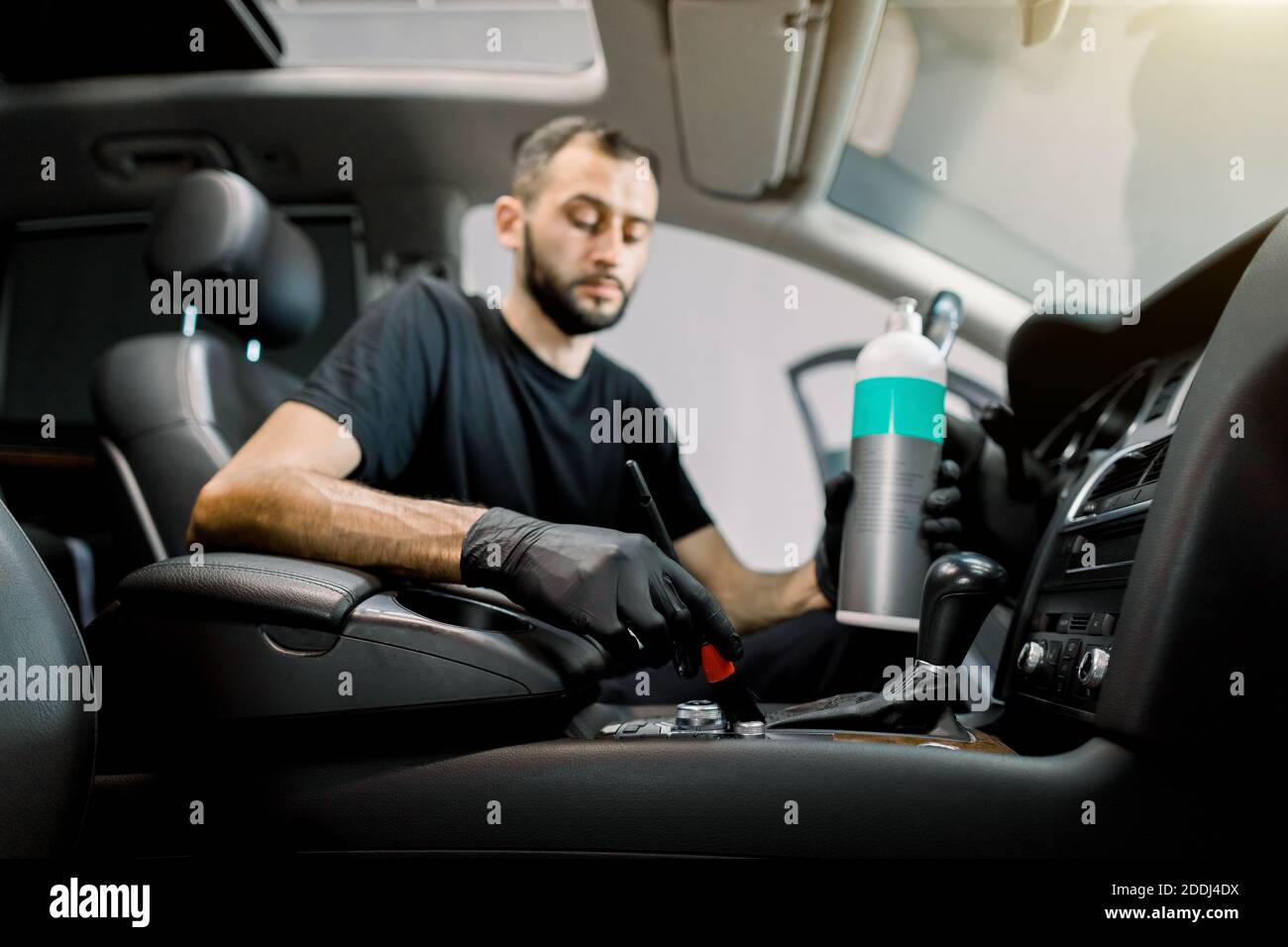 Car interior plastic care, detailing concept. Portrait of young