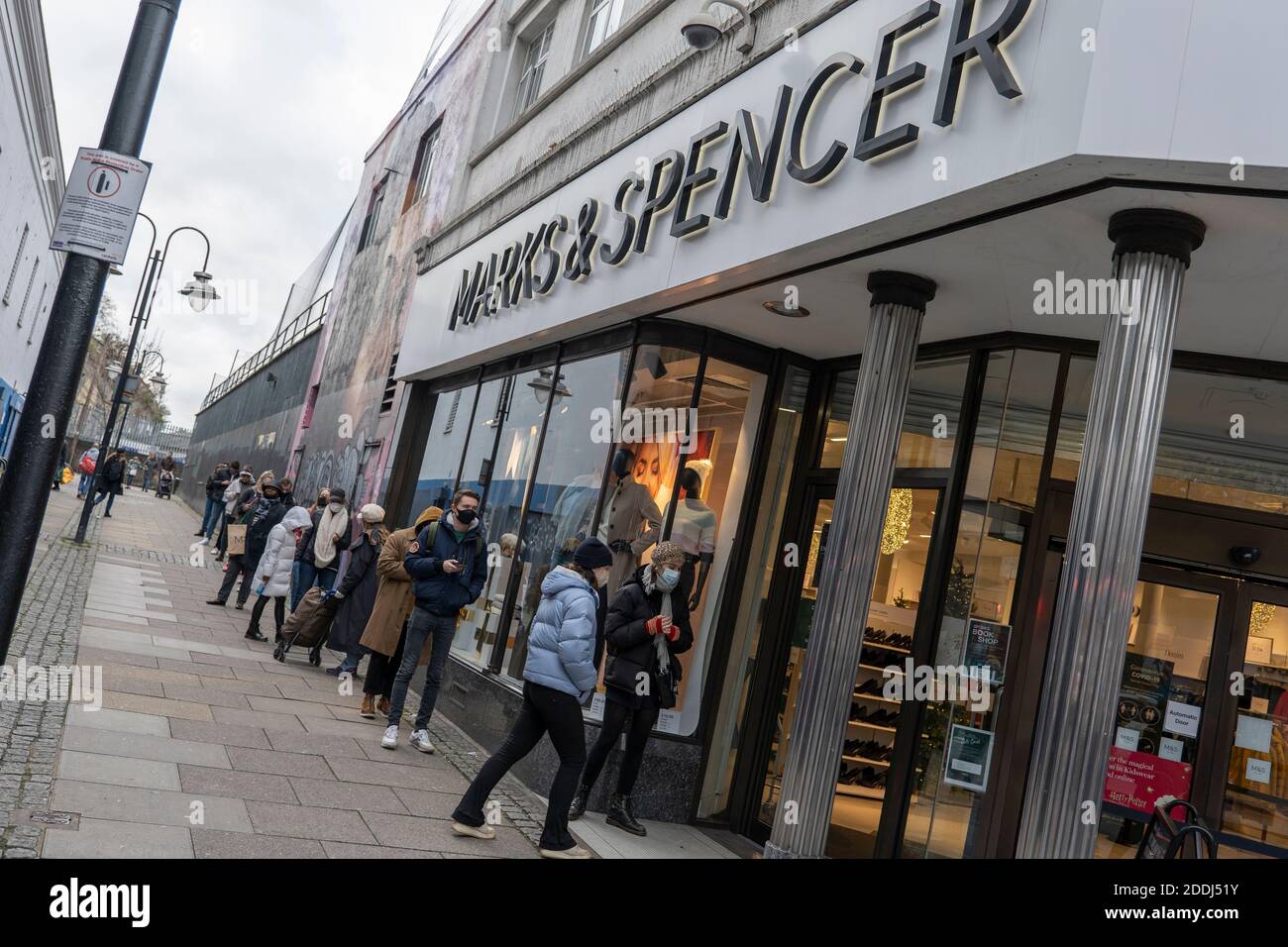 People queuing outside Marks & Spencer during the second UK Covid-19 lockdown on the 21st November 2020 in Brixton in London, England. Stock Photo