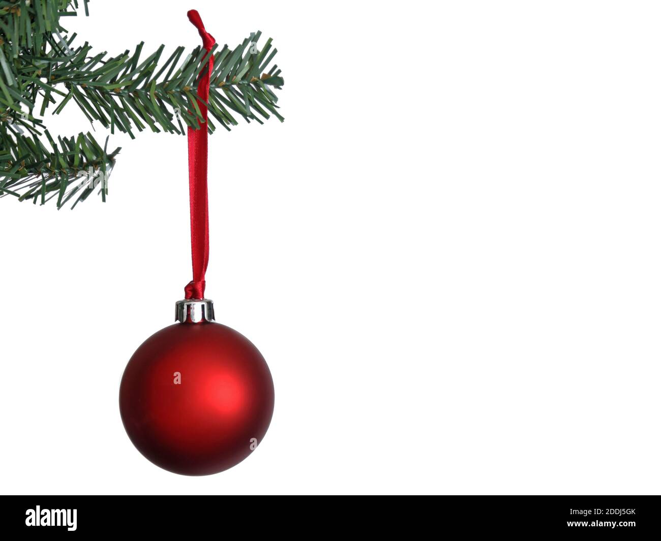 a large red Christmas tree ornament hanging on a thin red ribbon isolated  on white Stock Photo