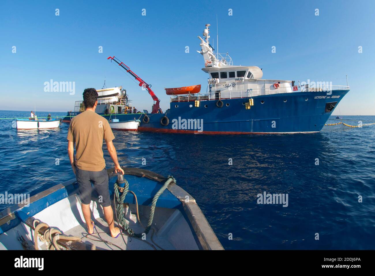 Picture of fishing rods and reels on a boat that is offshore