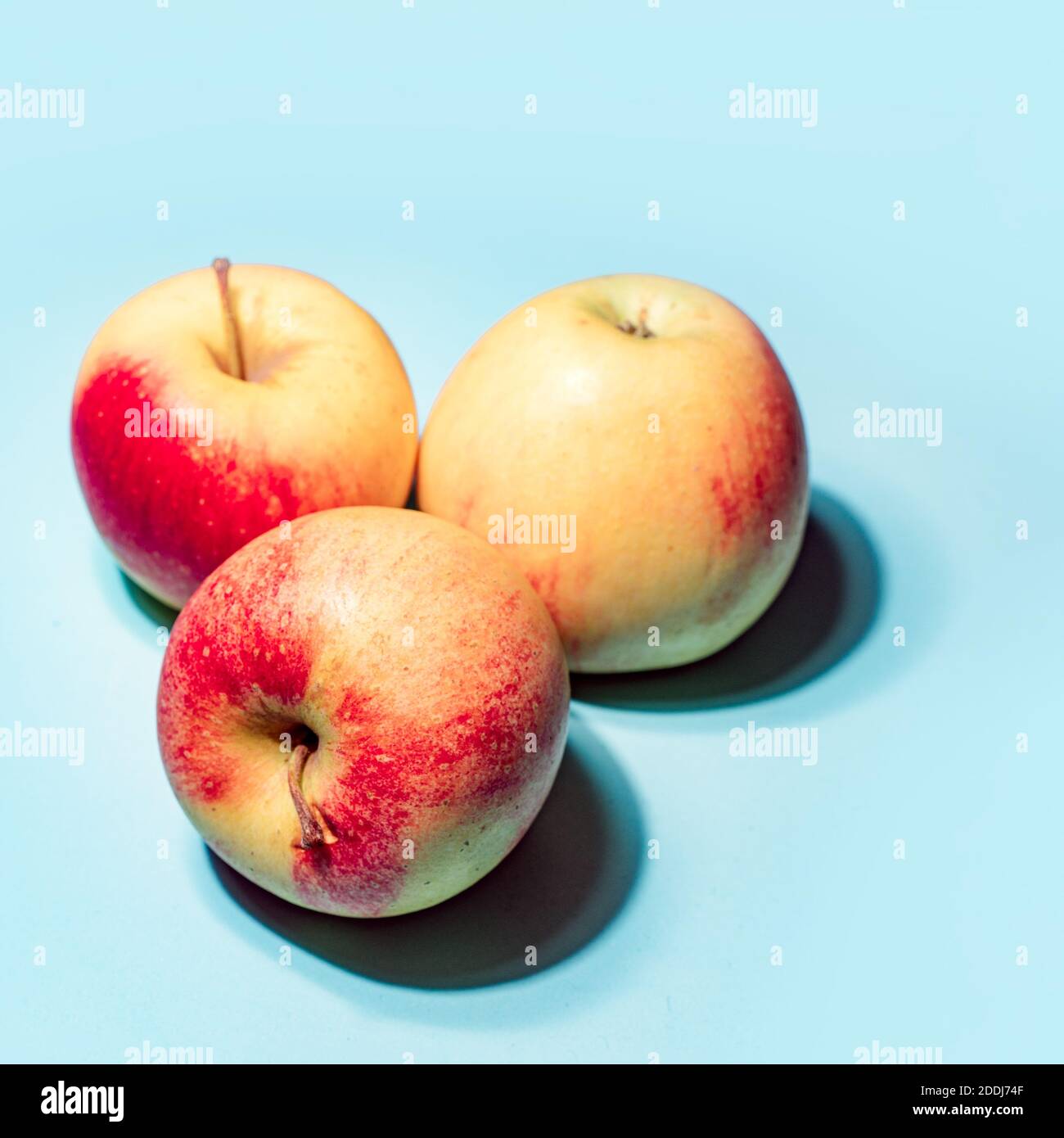 Apples on blue background art image Stock Photo